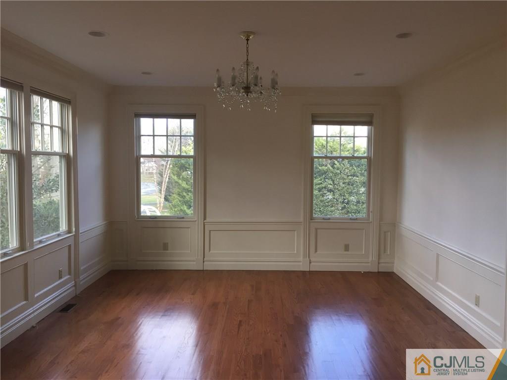 69 Athens Road Short Hills, NJ 07078 - Photo 5 of 25 an empty room with wooden floor and windows