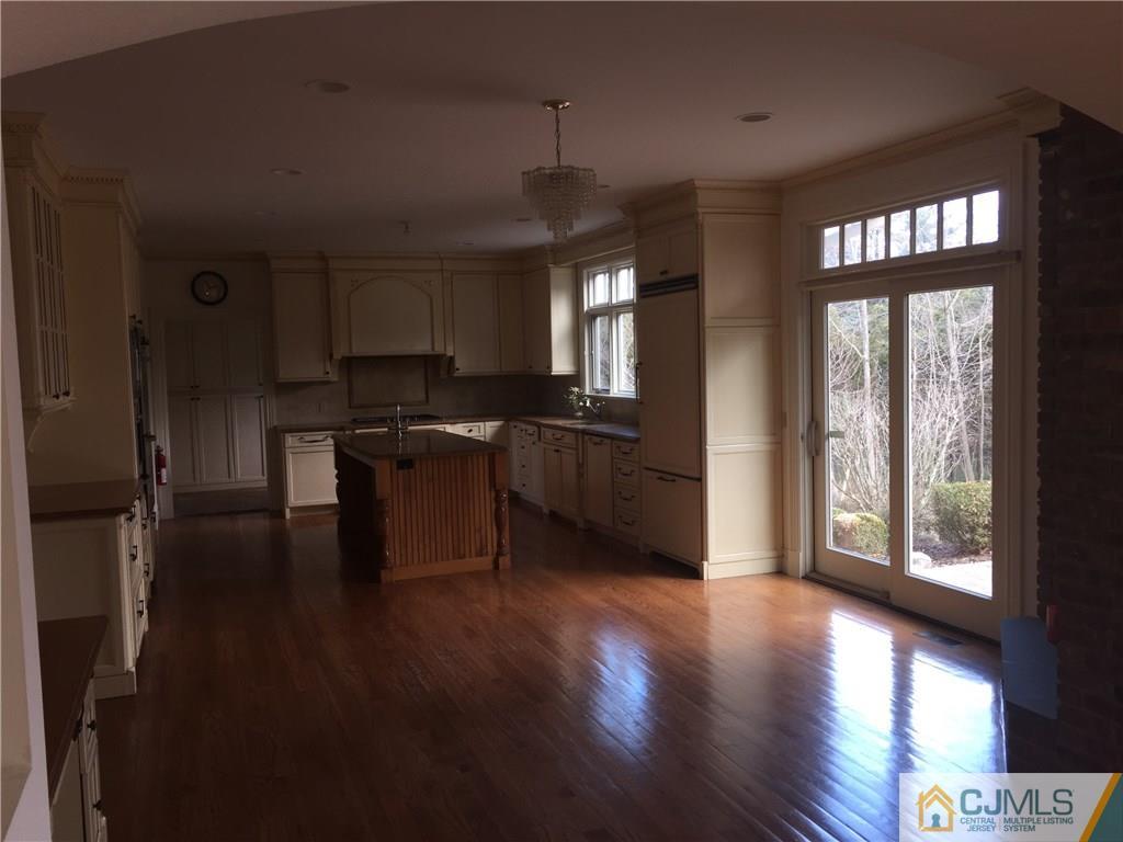 69 Athens Road Short Hills, NJ 07078 - Photo 6 of 25 a kitchen with granite countertop a stove a sink and a wooden floor