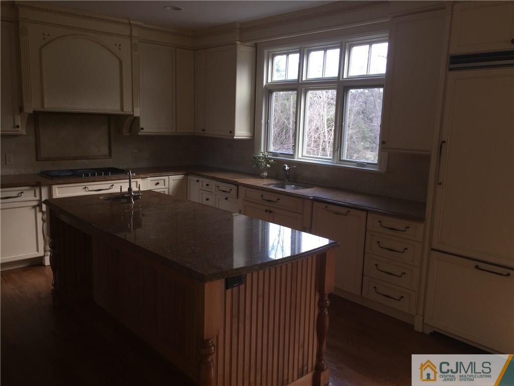 69 Athens Road Short Hills, NJ 07078 - Photo 7 of 25 a kitchen with granite countertop a sink stove and cabinets