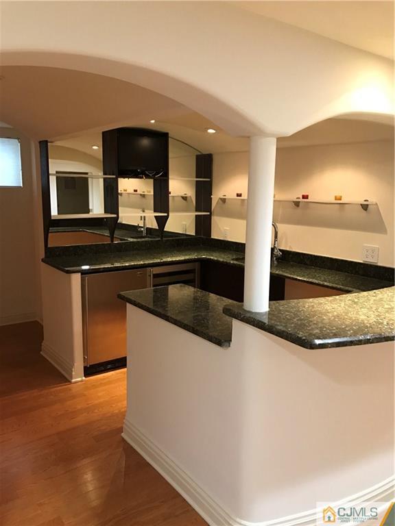 69 Athens Road Short Hills, NJ 07078 - Photo 8 of 25 a kitchen with stainless steel appliances granite countertop a sink and a stove top oven