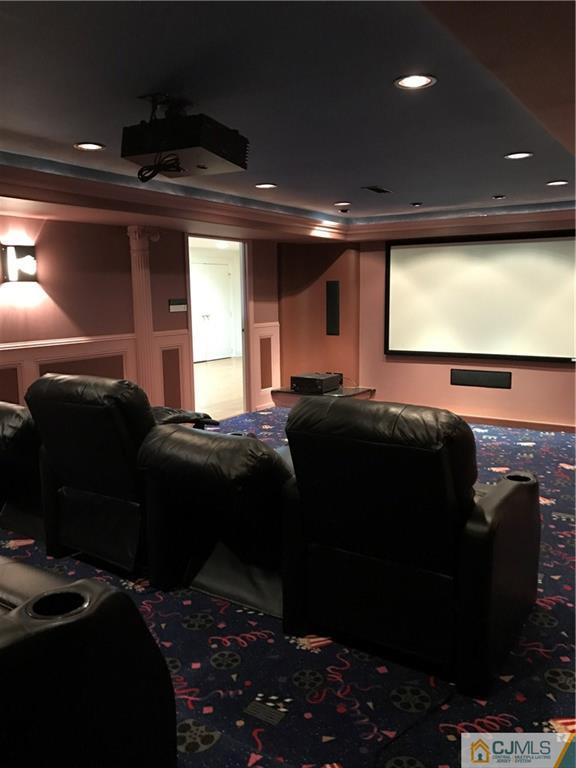 69 Athens Road Short Hills, NJ 07078 - Photo 9 of 25 a bedroom with a bed and a projector