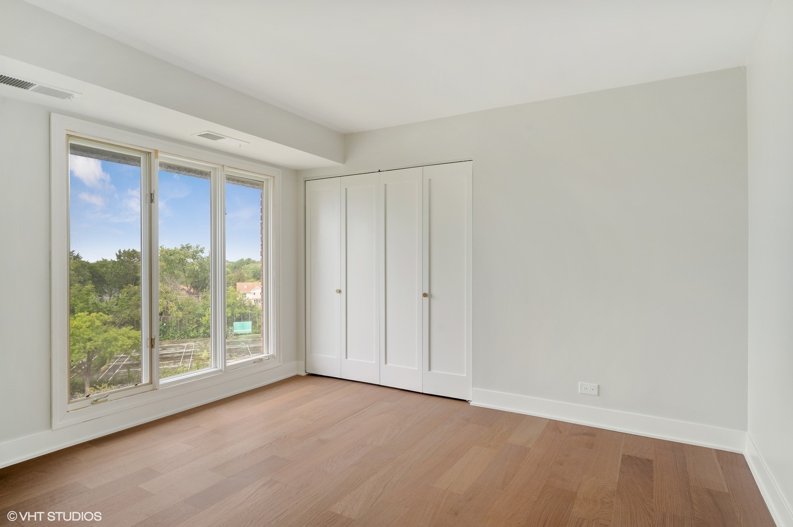 3801 Mission Hills Road, Unit 510 Northbrook, IL 60062 - Photo 14 of 21 a view of an empty room with wooden floor and a window