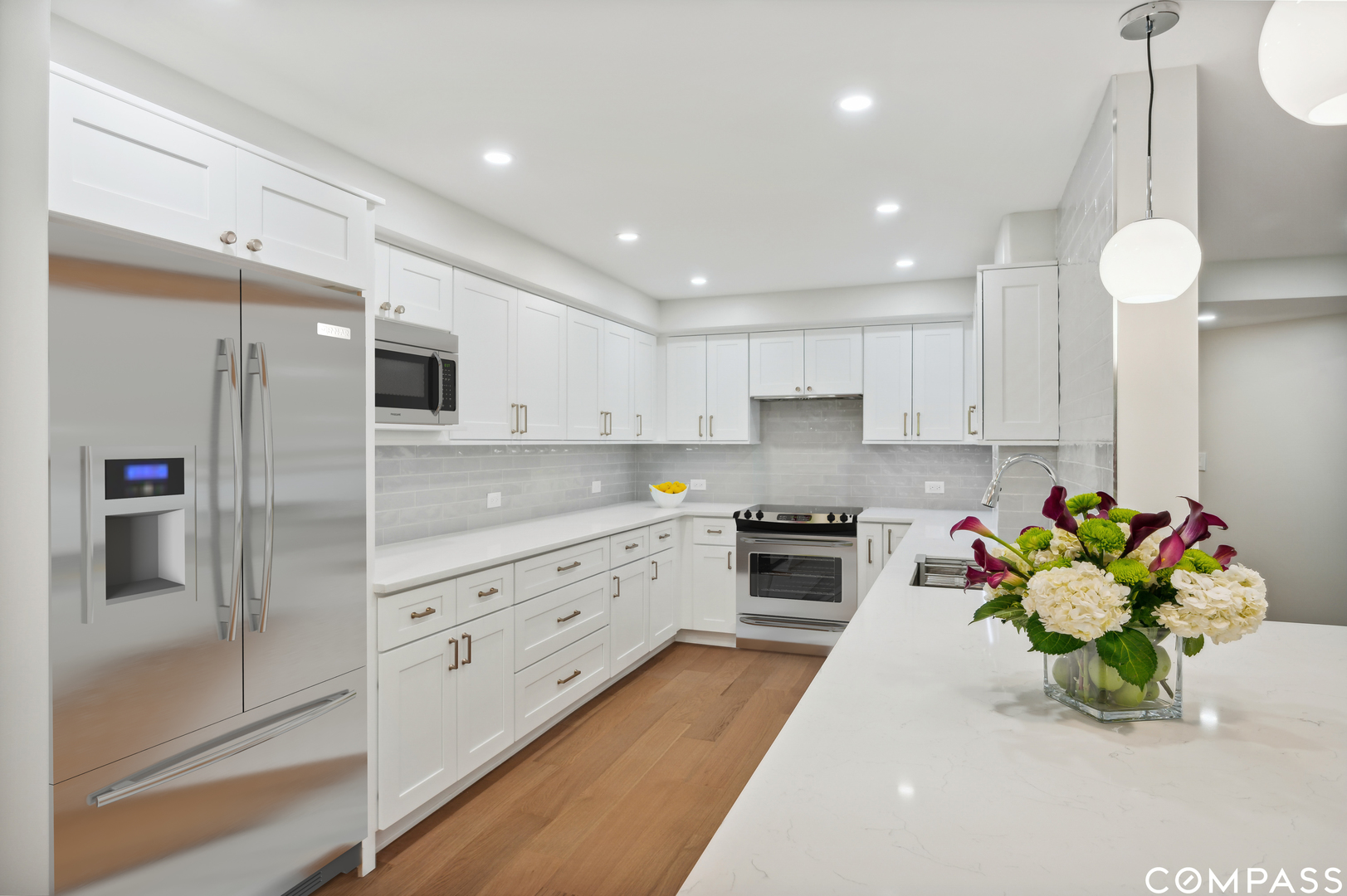 3801 Mission Hills Road, Unit 510 Northbrook, IL 60062 - Photo 4 of 21 a kitchen with stainless steel appliances kitchen island granite countertop a refrigerator a stove a sink dishwasher and white cabinets with wooden floor