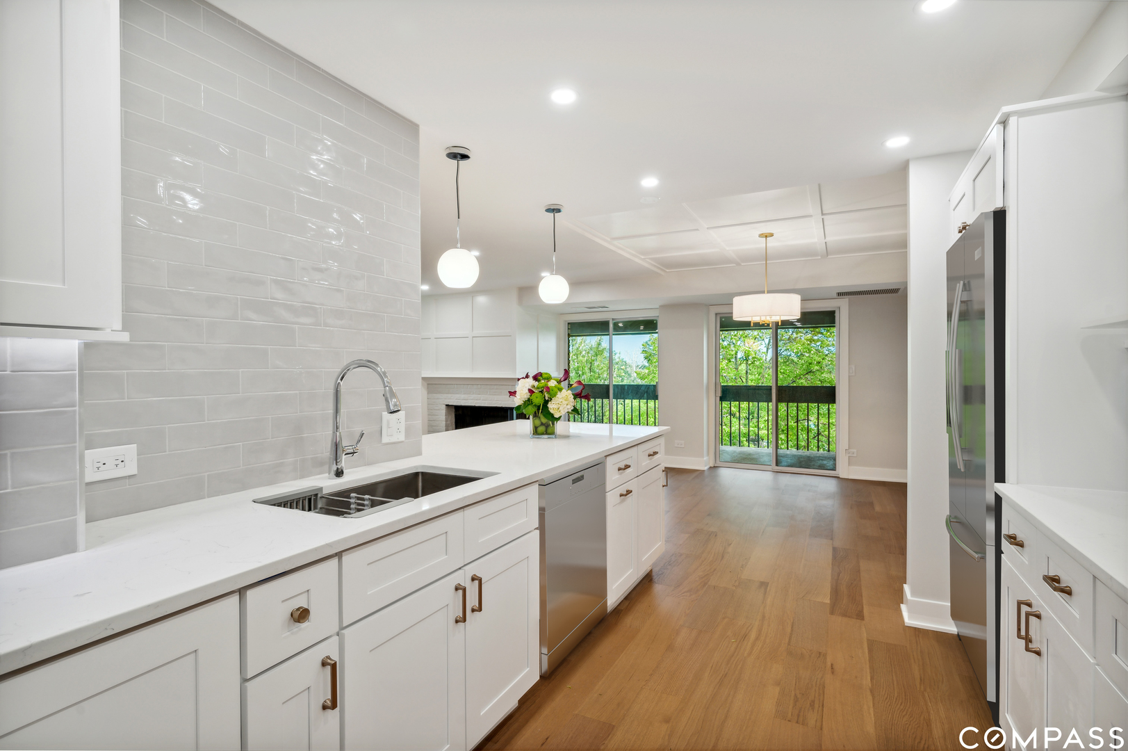 3801 Mission Hills Road, Unit 510 Northbrook, IL 60062 - Photo 6 of 21 a large kitchen with kitchen island white cabinets and wooden floor