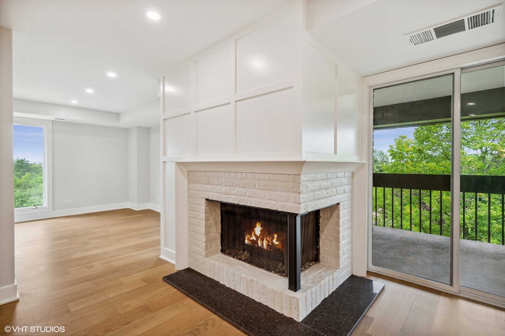 3801 Mission Hills Road, Unit 510 Northbrook, IL 60062 - Photo 8 of 21 a living room with a fireplace and a floor to ceiling window