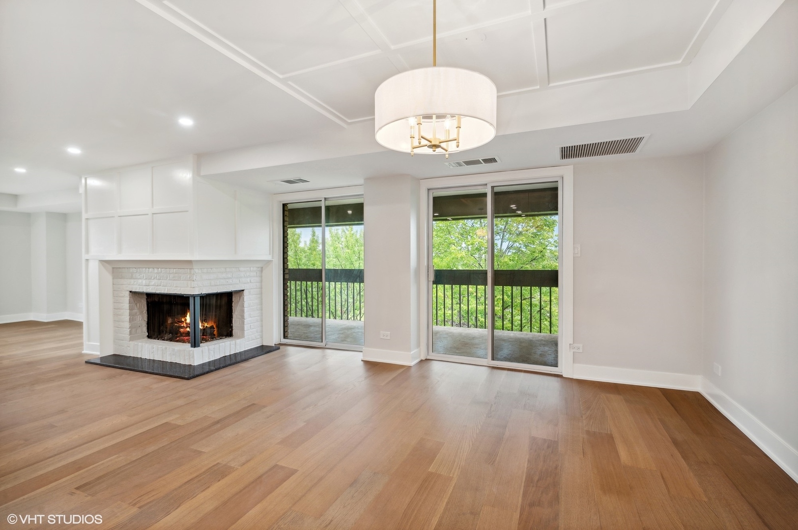 3801 Mission Hills Road, Unit 510 Northbrook, IL 60062 - Photo 9 of 21 a view of an empty room with wooden floor fireplace and a window
