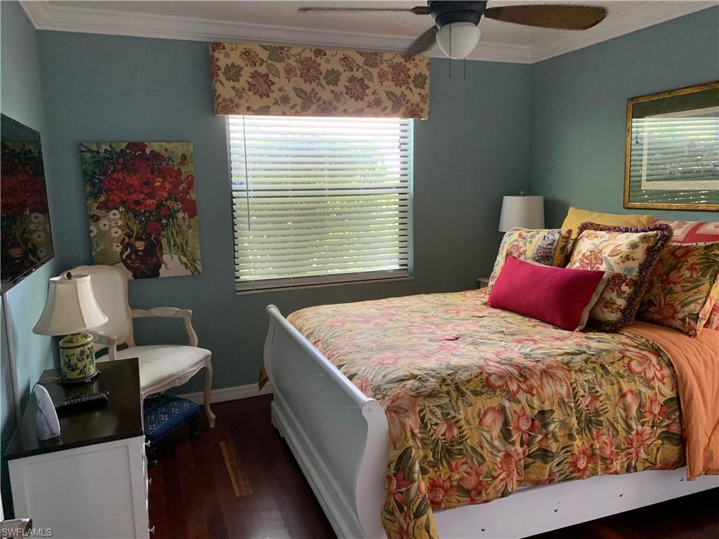 1747 Sandpiper Street, Unit B Naples, FL 34112 - Photo 15 of 29 a bed sitting in a bedroom next to a window