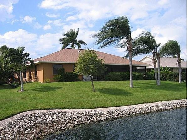 1747 Sandpiper Street, Unit B Naples, FL 34112 - Photo 19 of 29 a house with green field in front of it
