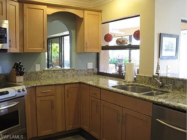 a kitchen with a sink and cabinets