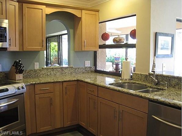 1747 Sandpiper Street, Unit B Naples, FL 34112 - Photo 7 of 29 a kitchen with a sink and cabinets