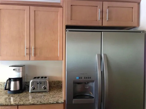 a kitchen with a refrigerator and cabinets