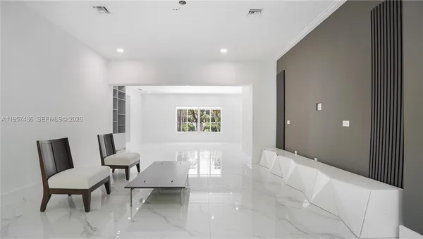 a view of a hallway with seating area