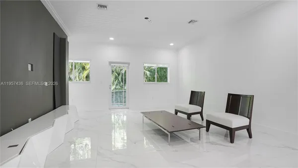 a living room with furniture and a chair