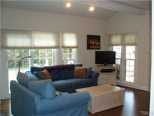 546 Dogeye Road Benson, NC 27504 - Photo 8 of 23 SITTING AREA. FEATURING HARDWOOD FLOORING AND FIREPLACE.