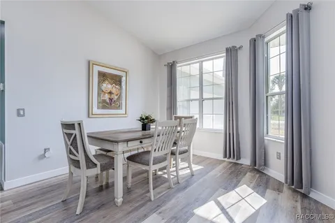 a view of a dining room with furniture and windows