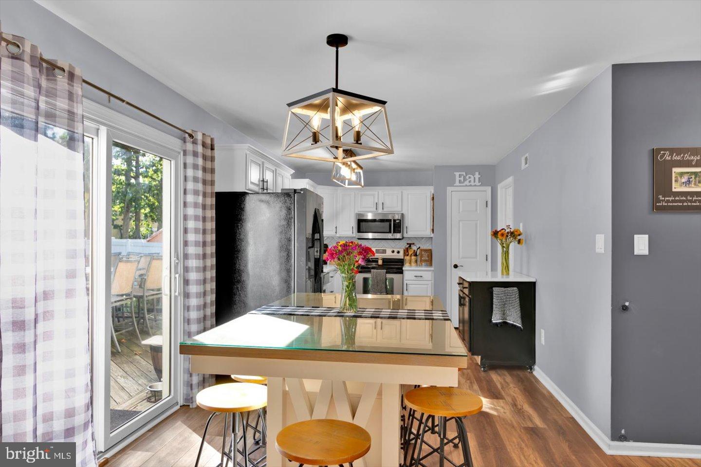 388 Sapling Way Atco, NJ 08004 - Photo 11 of 49 a view of a dining room with furniture a chandelier windows and wooden floor