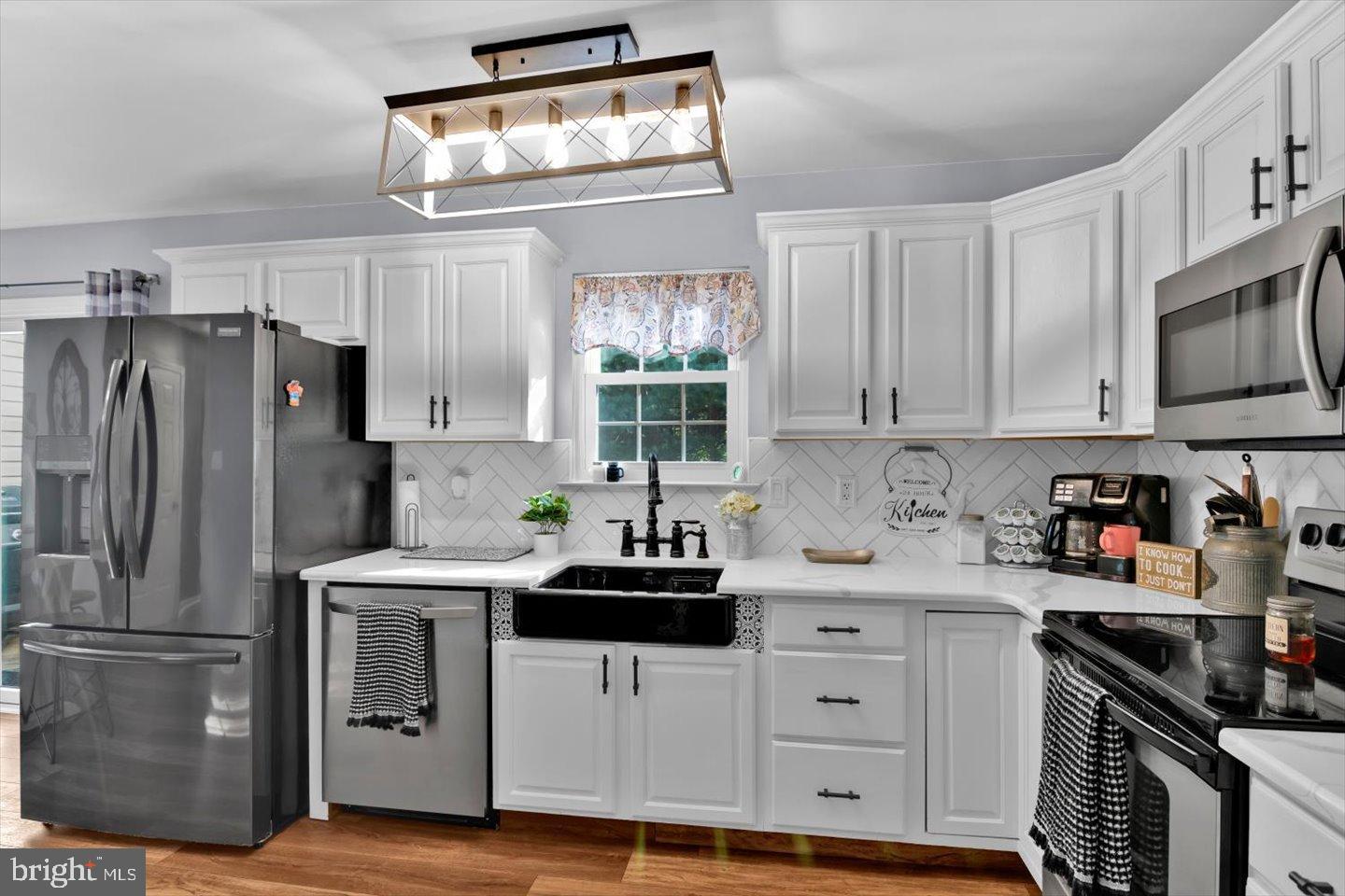 388 Sapling Way Atco, NJ 08004 - Photo 14 of 49 a kitchen with white cabinets and stainless steel appliances