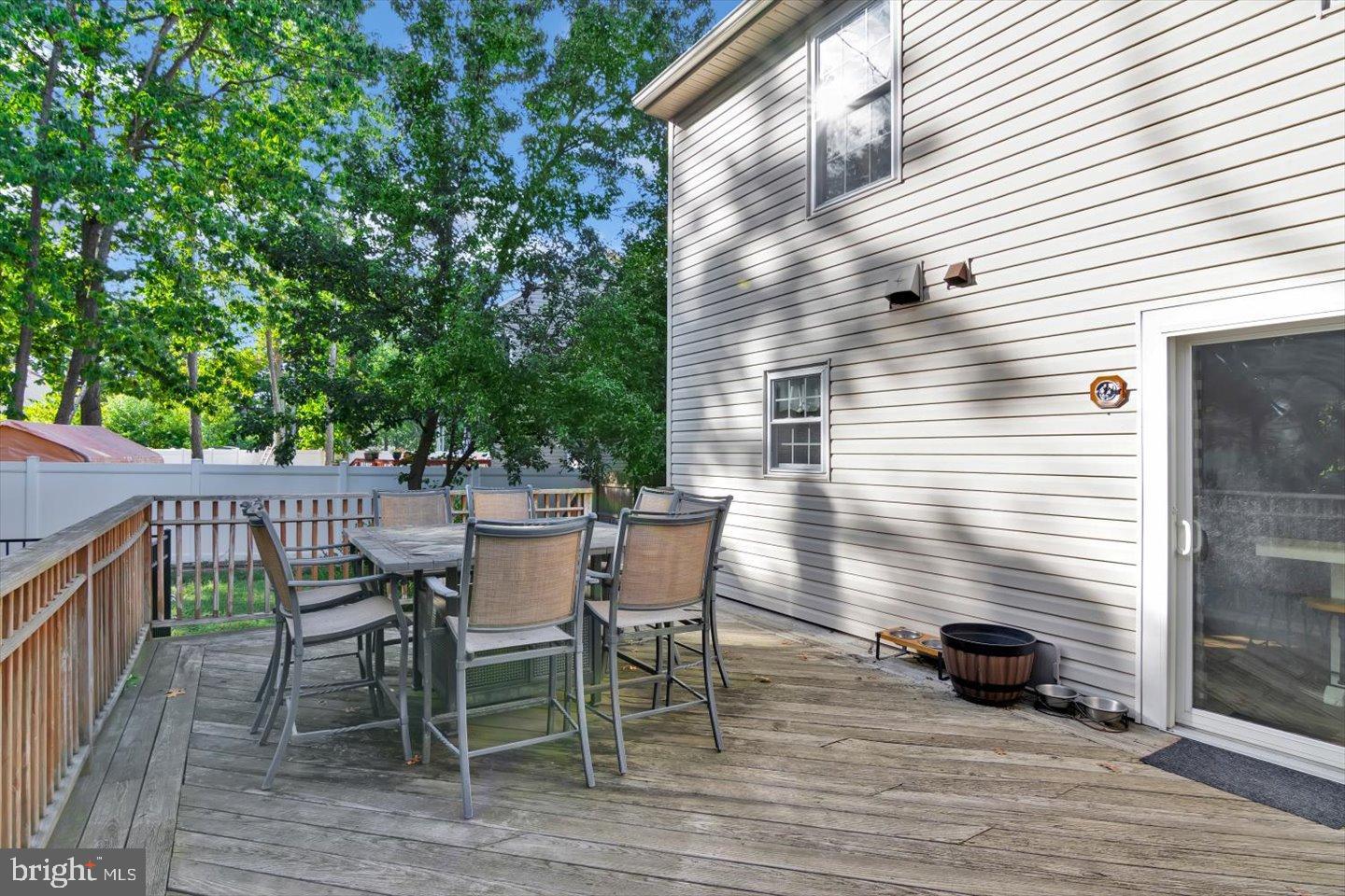 388 Sapling Way Atco, NJ 08004 - Photo 40 of 49 a view of a roof deck with table and chairs and wooden floor