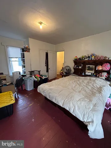 a bedroom with bed and a window