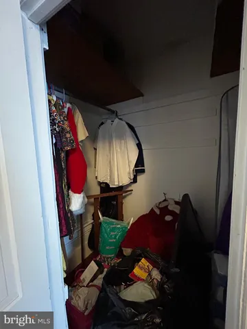 a living room with furniture a chandelier and a window