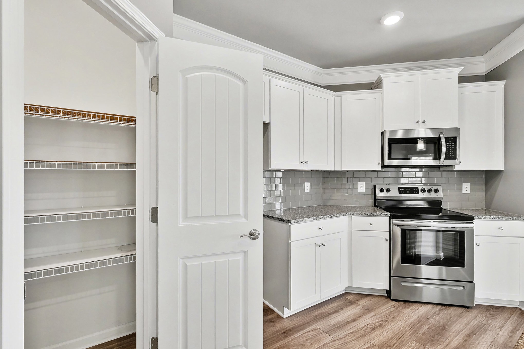 2932 Timewinder Way Columbia, TN 38401 - Photo 17 of 37 a kitchen with white cabinets and stainless steel appliances