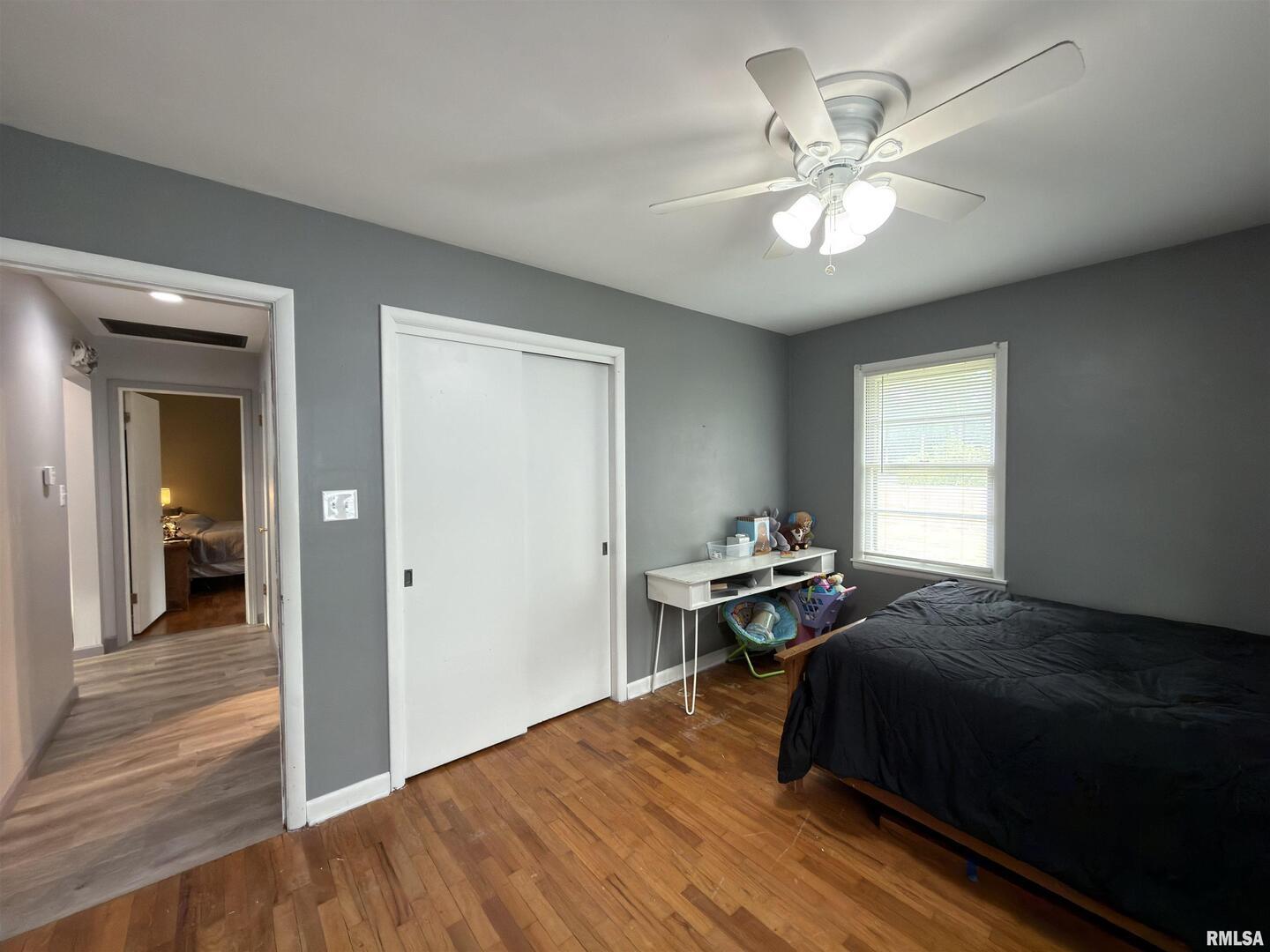 117 Marshall Place Carmi, IL 62821 - Photo 18 of 25 a bedroom with a bed and wooden floor