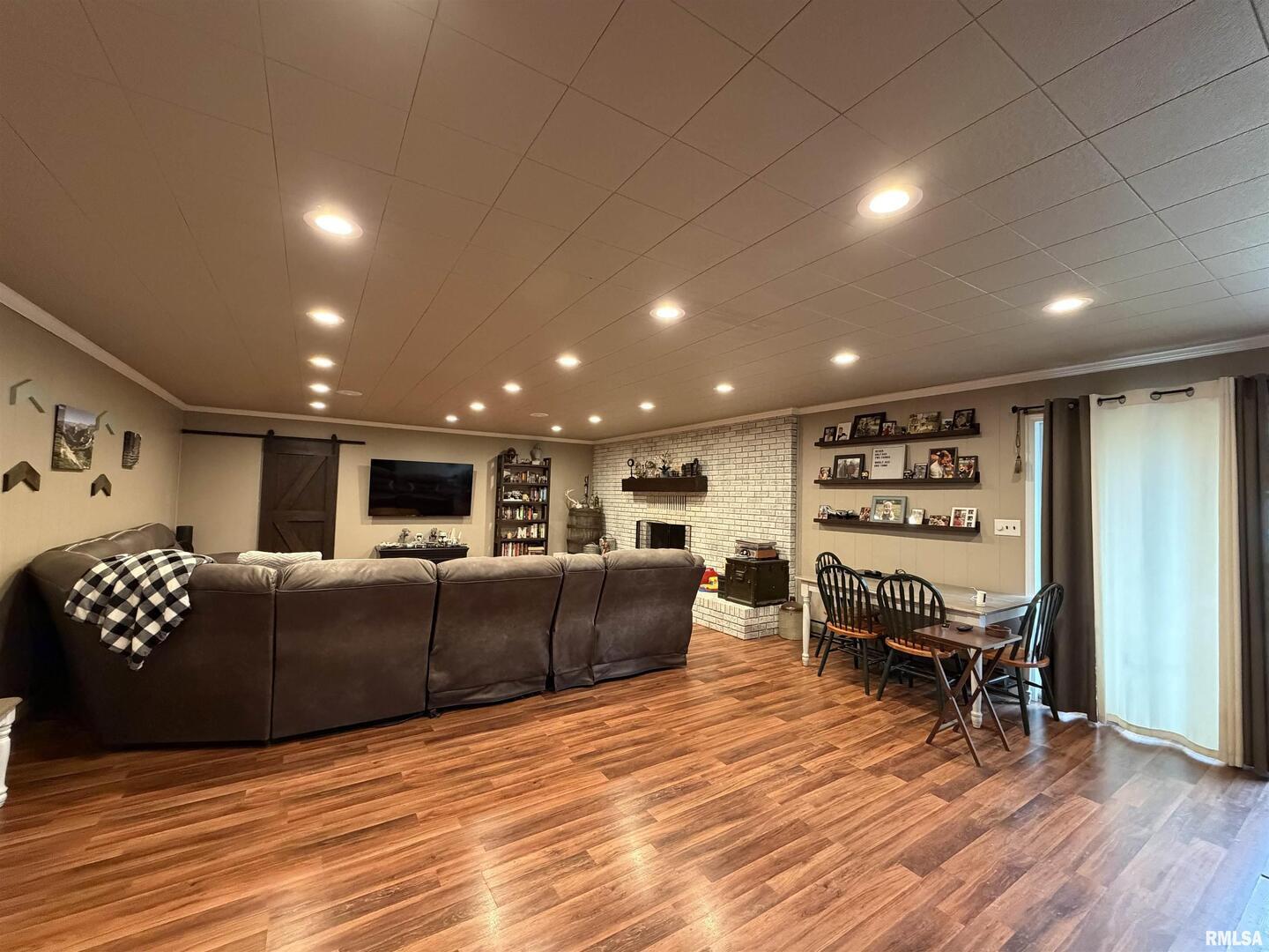 117 Marshall Place Carmi, IL 62821 - Photo 3 of 25 a living room with furniture a wooden floor and a flat screen tv