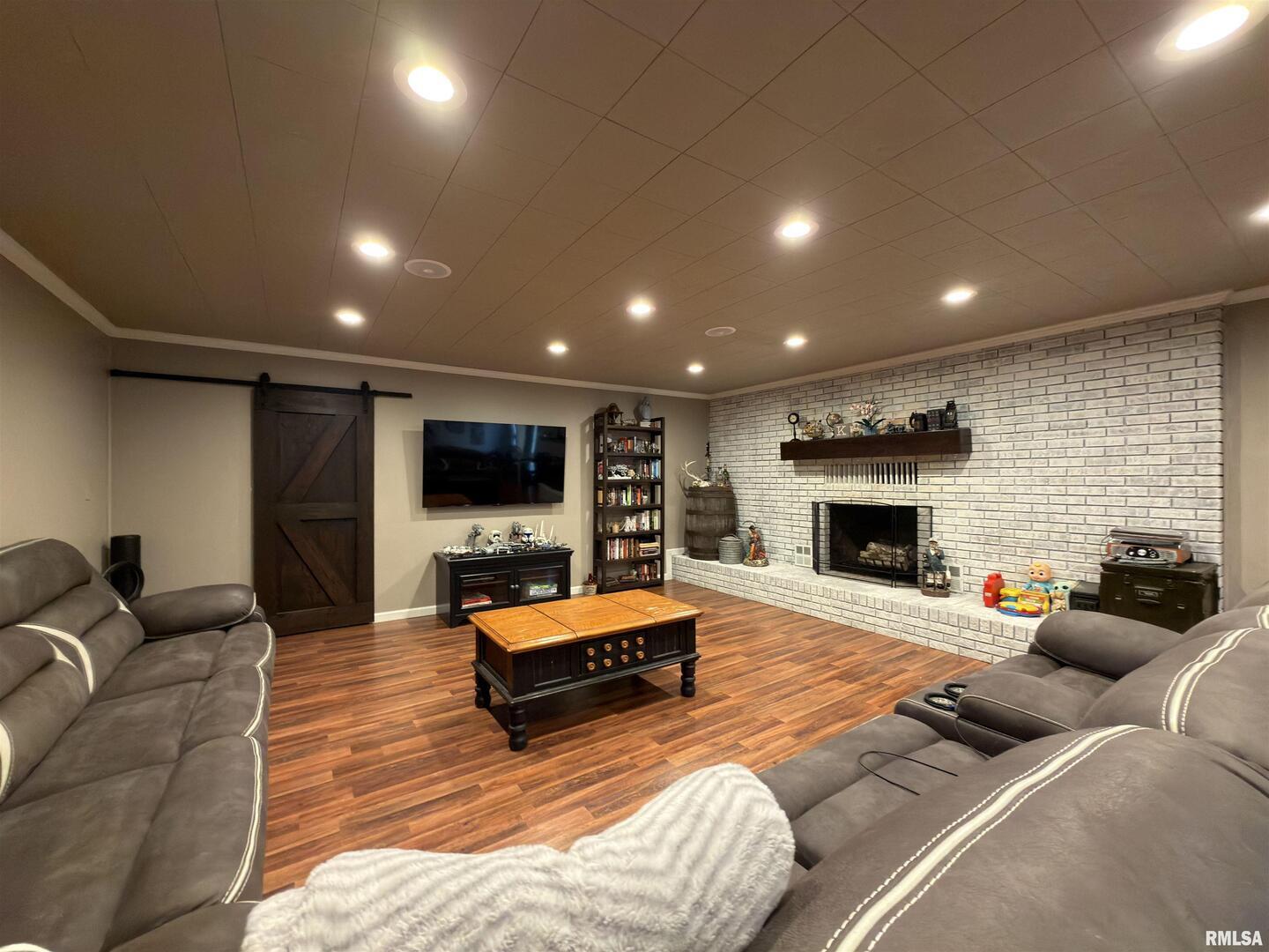 117 Marshall Place Carmi, IL 62821 - Photo 4 of 25 a living room with furniture a flat screen tv and a fireplace