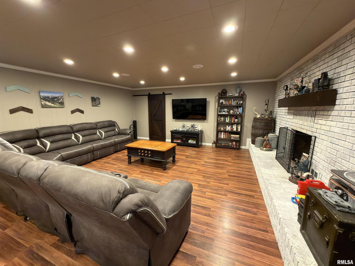 117 Marshall Place Carmi, IL 62821 - Photo 5 of 25 a living room with furniture a flat screen tv and a fireplace