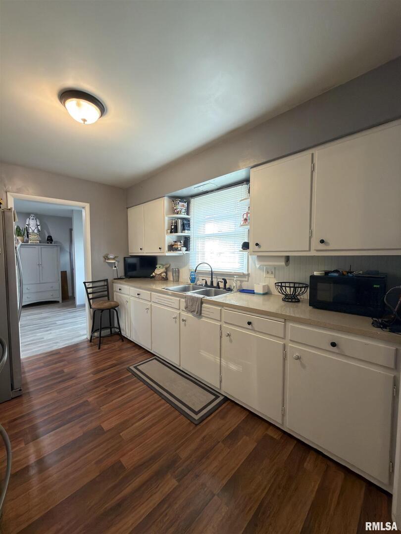 117 Marshall Place Carmi, IL 62821 - Photo 7 of 25 a kitchen with granite countertop white cabinets and white appliances
