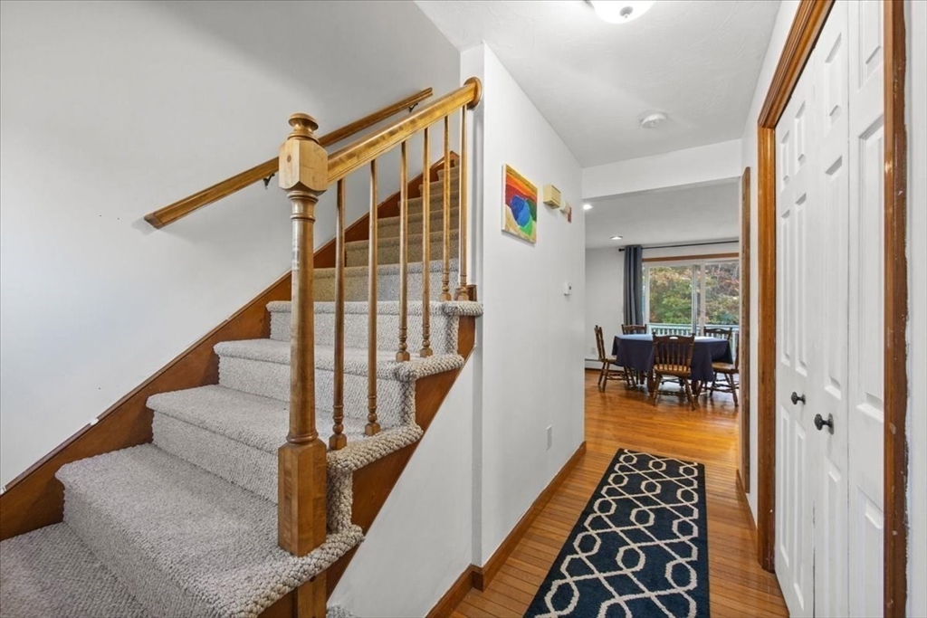 23 Heather Hill Road Bourne, MA 02532 - Photo 8 of 34 a hallway with wooden floor and furniture
