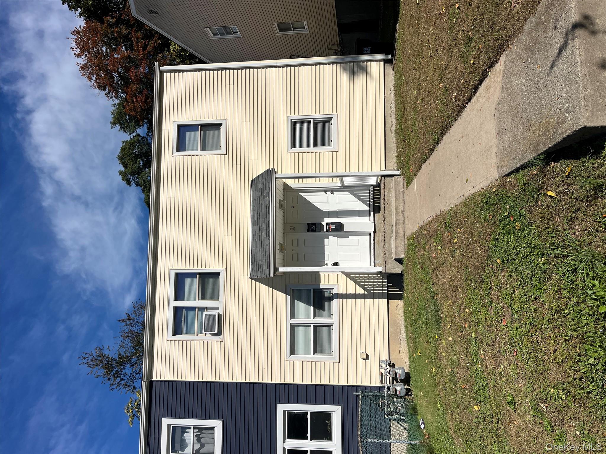 21 Vernon Terrace, Unit 1 Poughkeepsie, NY 12601 - Photo 1 of 23 a front view of a house with a yard