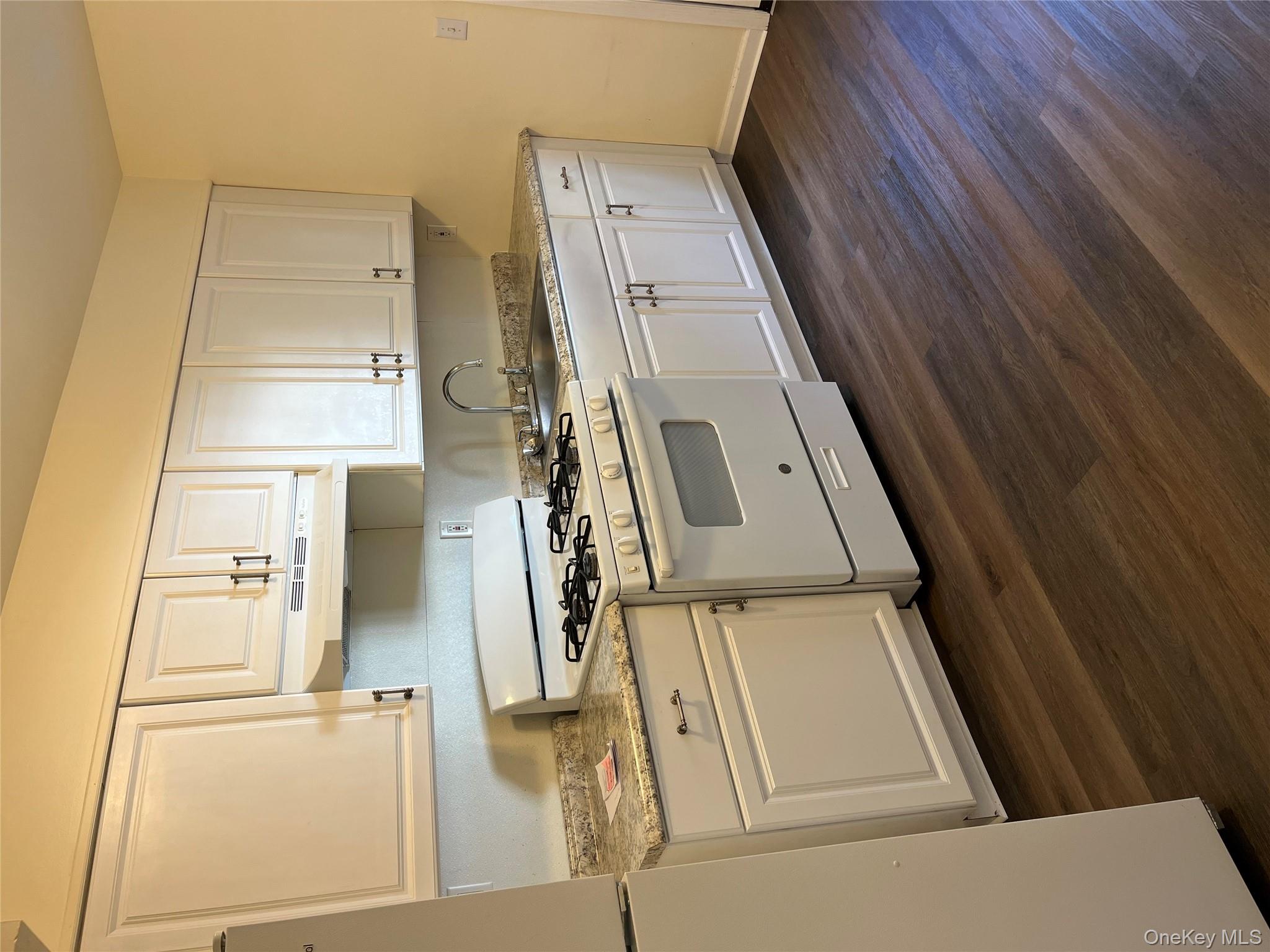 21 Vernon Terrace, Unit 1 Poughkeepsie, NY 12601 - Photo 11 of 23 a white stove top oven sitting inside of a kitchen