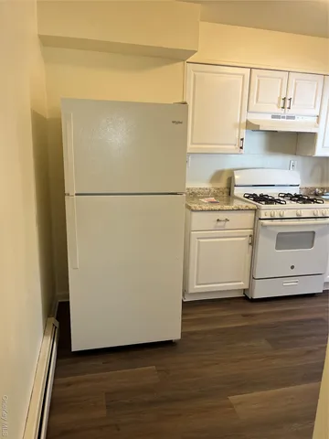 a white refrigerator freezer sitting in a kitchen