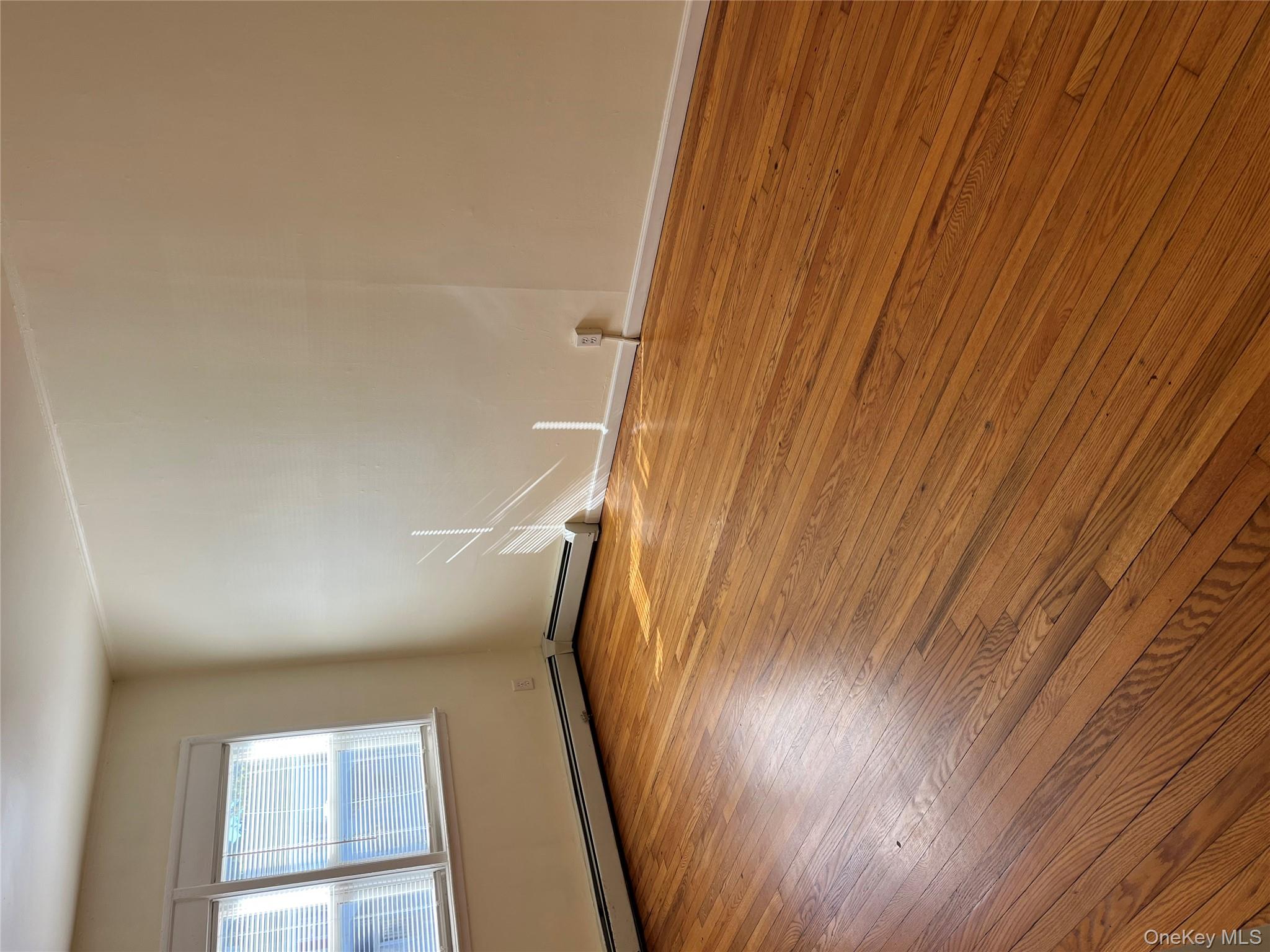 21 Vernon Terrace, Unit 1 Poughkeepsie, NY 12601 - Photo 16 of 23 an empty room with wooden floor and windows