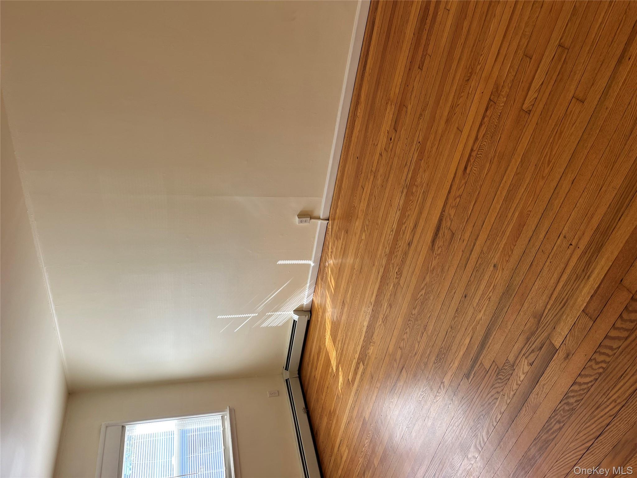 21 Vernon Terrace, Unit 1 Poughkeepsie, NY 12601 - Photo 17 of 23 an empty room with wooden floor and windows