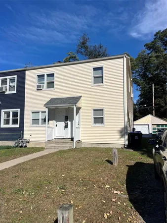 a backyard of a house with yard fire pit and outdoor seating