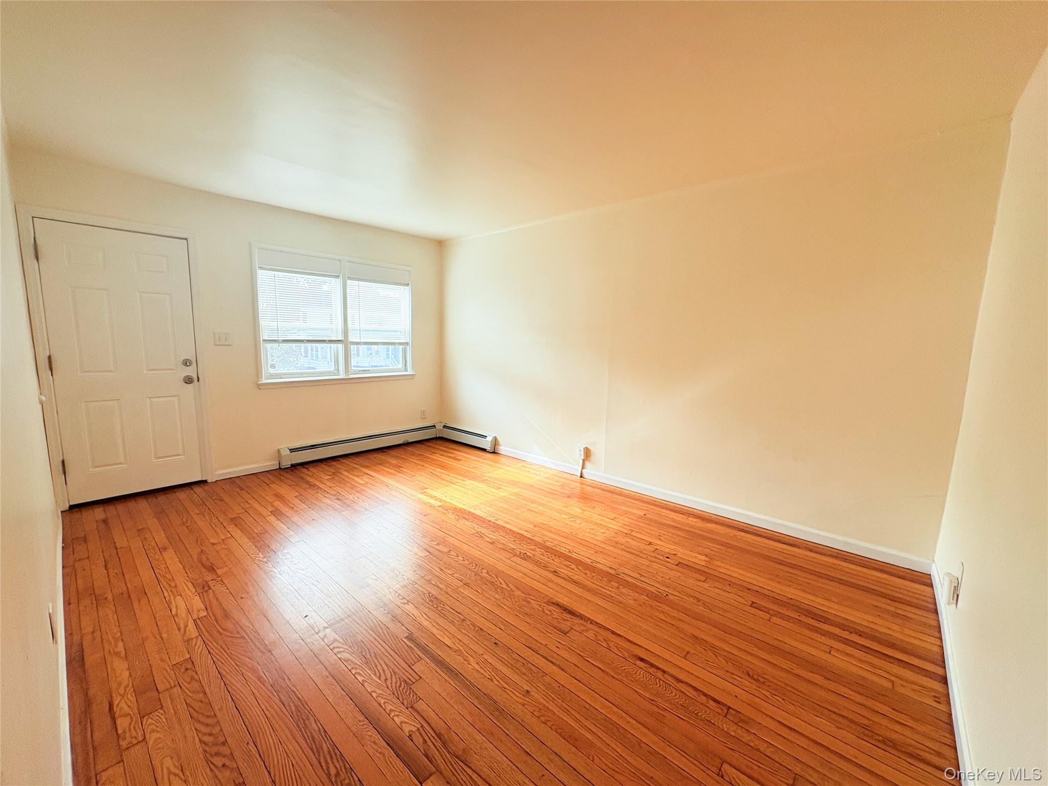 21 Vernon Terrace, Unit 1 Poughkeepsie, NY 12601 - Photo 4 of 23 an empty room with wooden floor and windows