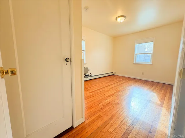a view of a room with wooden floor