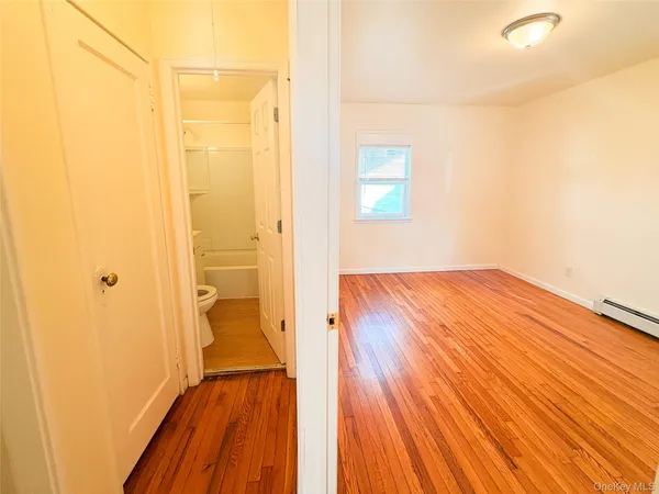 a view of a room with wooden floor and a balcony