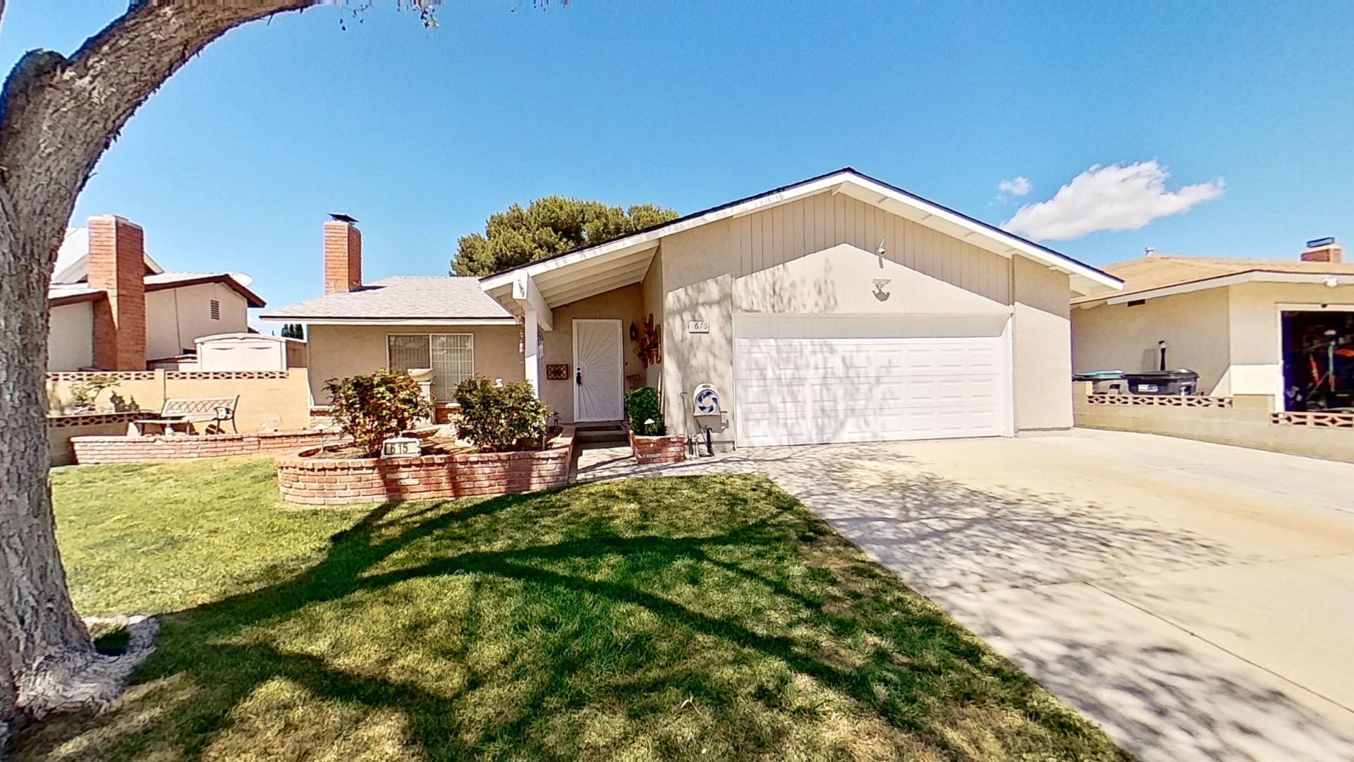 a view of a house with backyard porch and sitting area