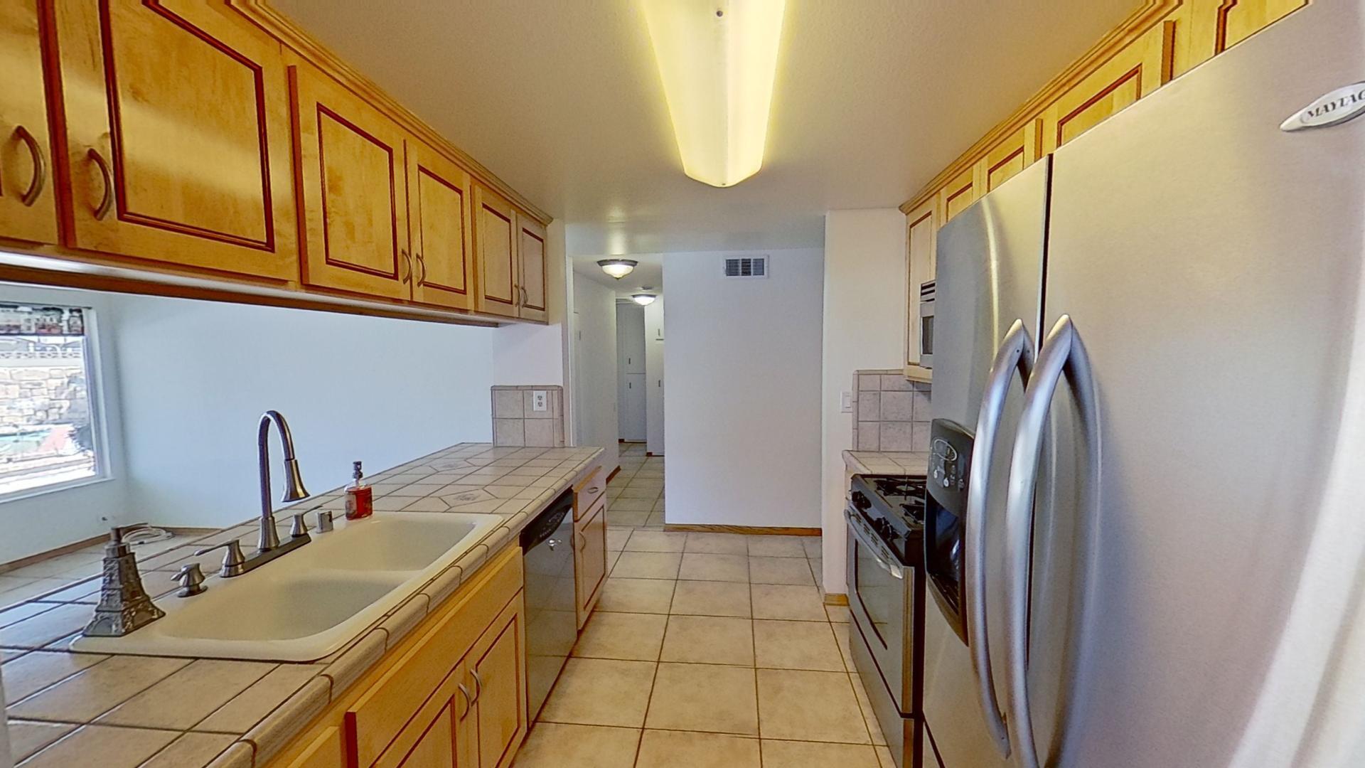 615 Eston Place Lancaster, CA 93535 - Photo 11 of 46 a room with stainless steel appliances granite countertop a refrigerator and a stove