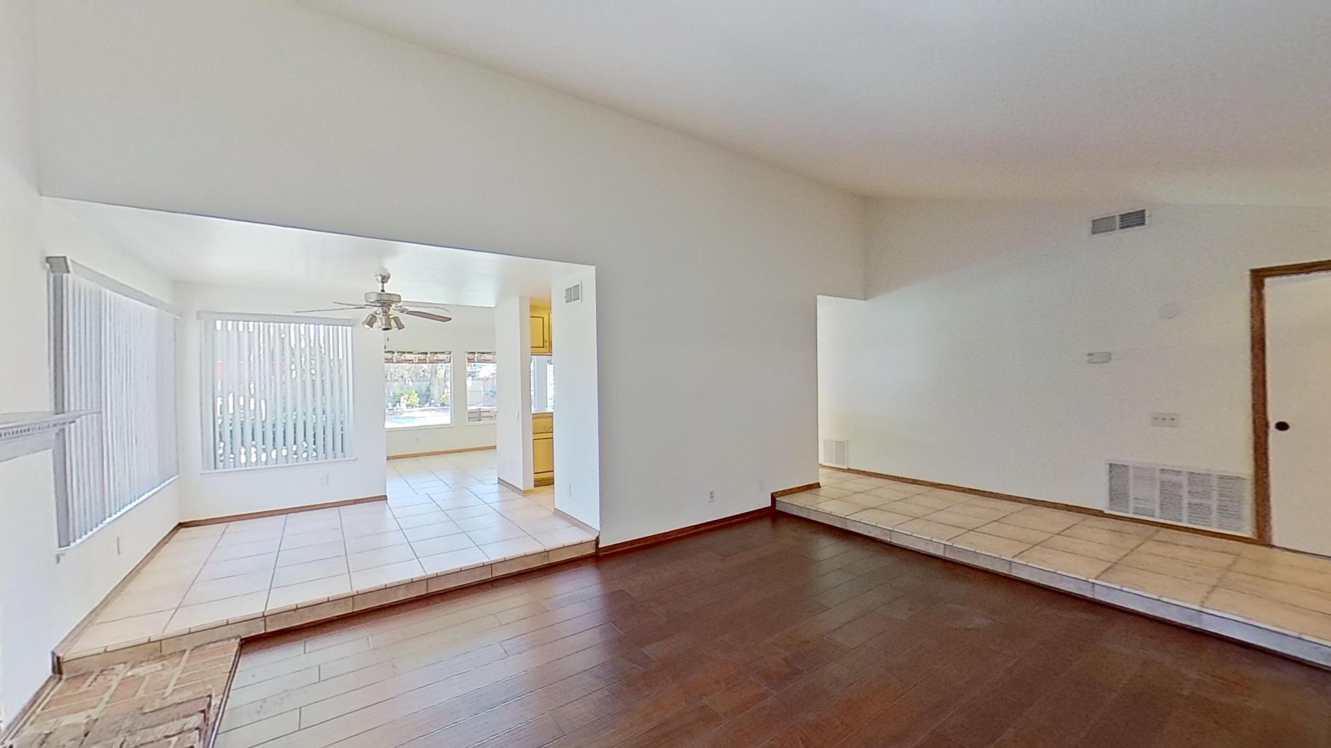 615 Eston Place Lancaster, CA 93535 - Photo 14 of 46 an empty room with wooden floor and windows