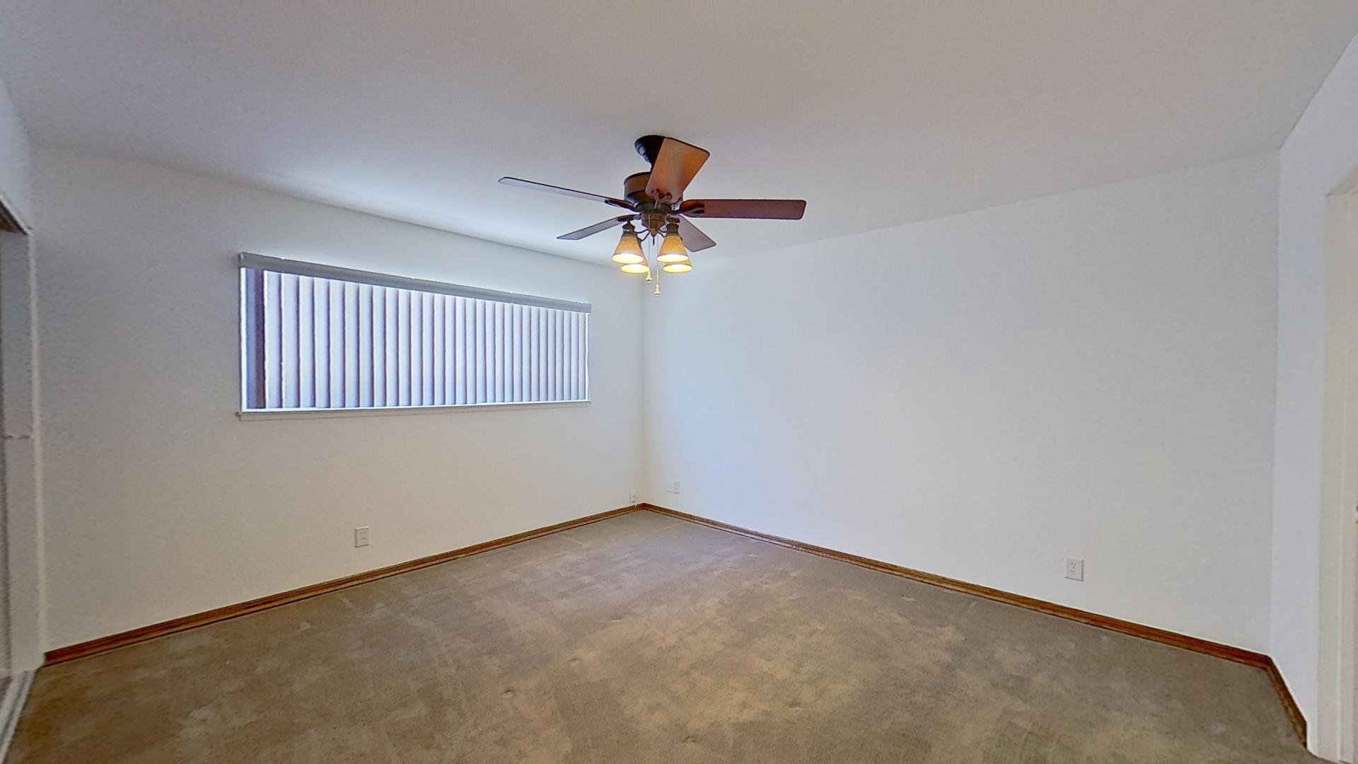615 Eston Place Lancaster, CA 93535 - Photo 19 of 46 an empty room with a ceiling fan and wooden floor