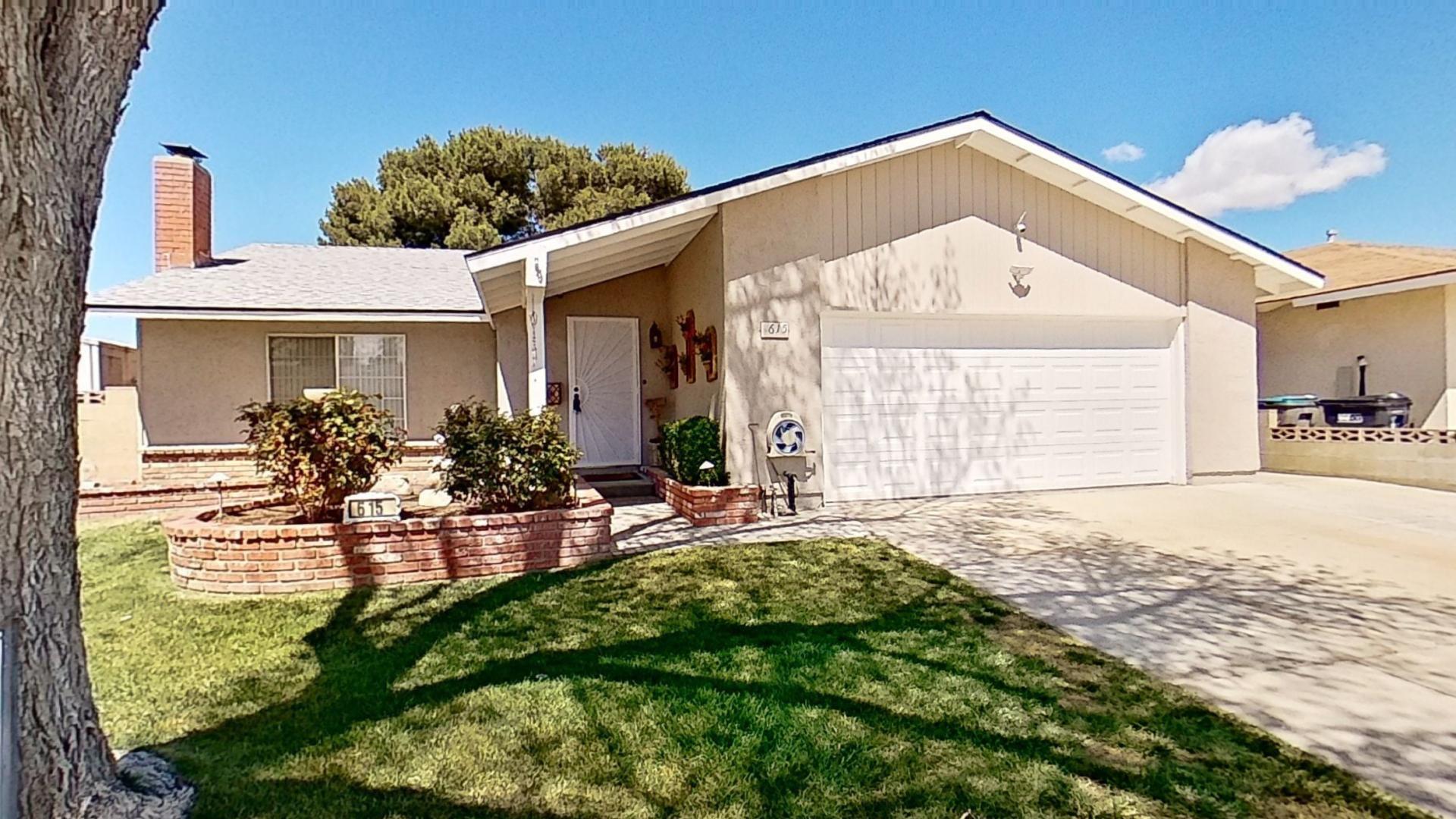 615 Eston Place Lancaster, CA 93535 - Photo 2 of 46 a front view of a house with garden
