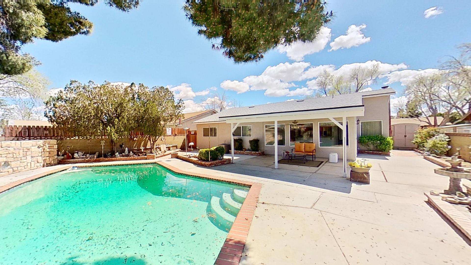 615 Eston Place Lancaster, CA 93535 - Photo 38 of 46 a view of a patio with table and chairs under an umbrella