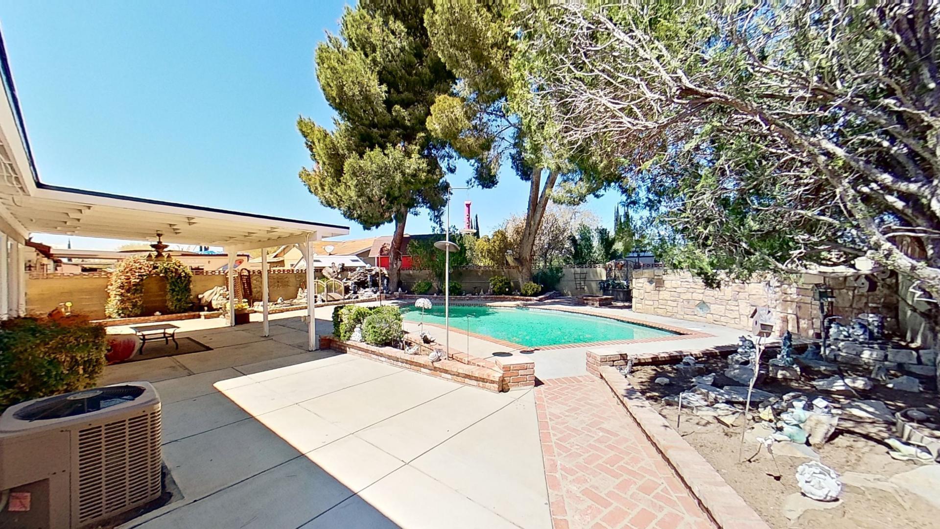 615 Eston Place Lancaster, CA 93535 - Photo 42 of 46 a view of a patio with a table and chairs under an umbrella