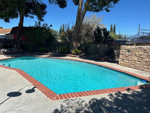 615 Eston Place Lancaster, CA 93535 - Photo 5 of 46 a view of a swimming pool with a yard