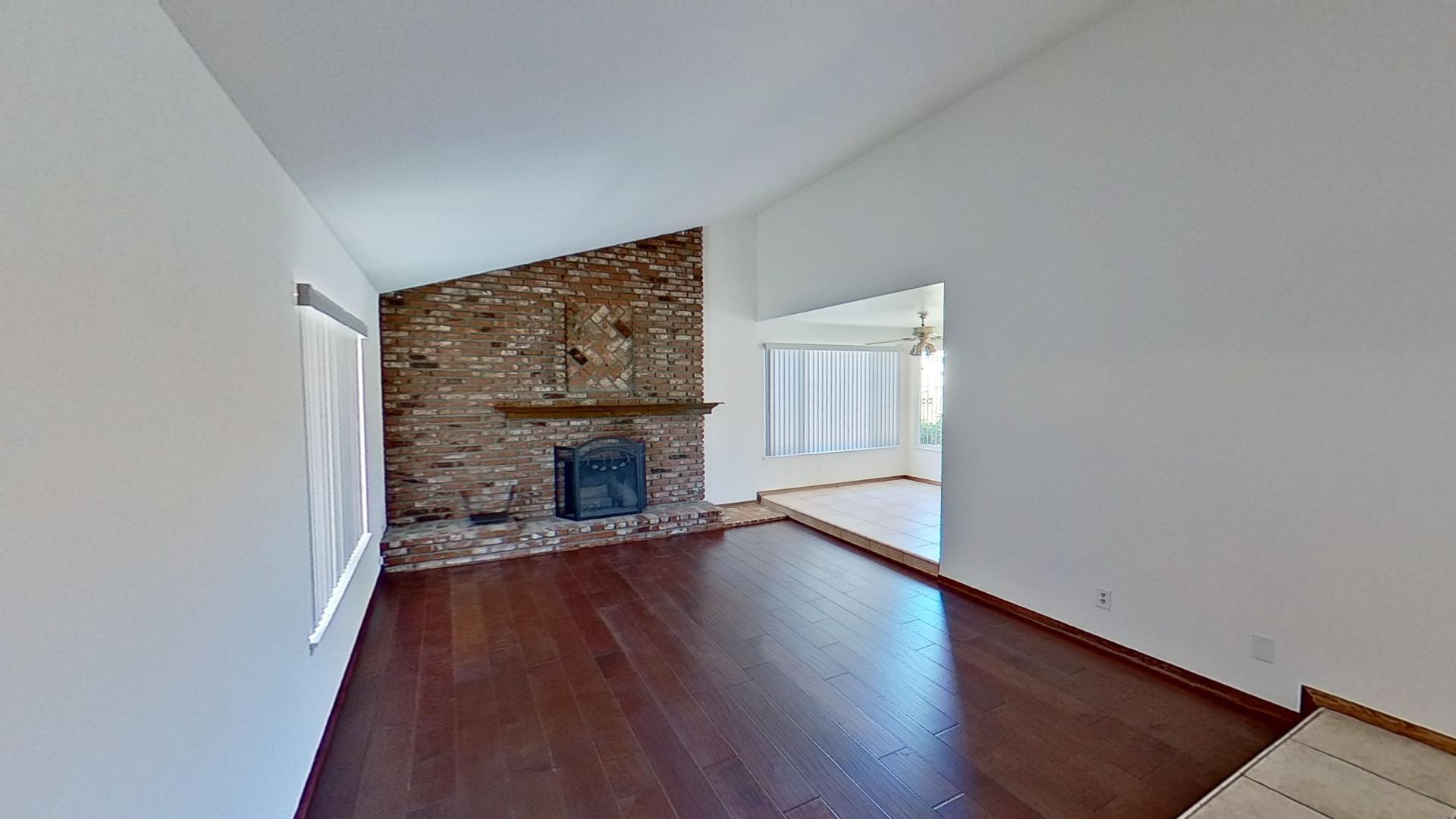 615 Eston Place Lancaster, CA 93535 - Photo 6 of 46 wooden floor fireplace and natural light in room