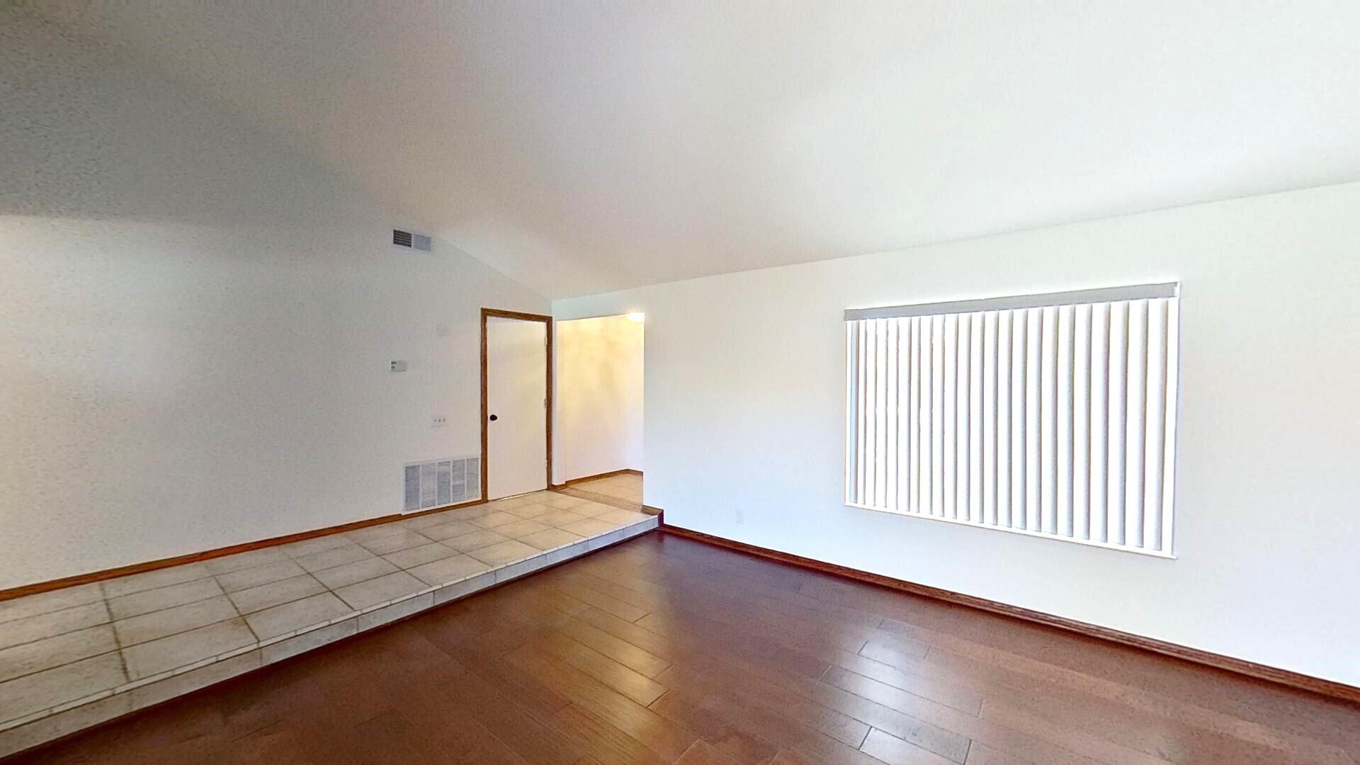 615 Eston Place Lancaster, CA 93535 - Photo 7 of 46 an empty room with wooden floor and windows